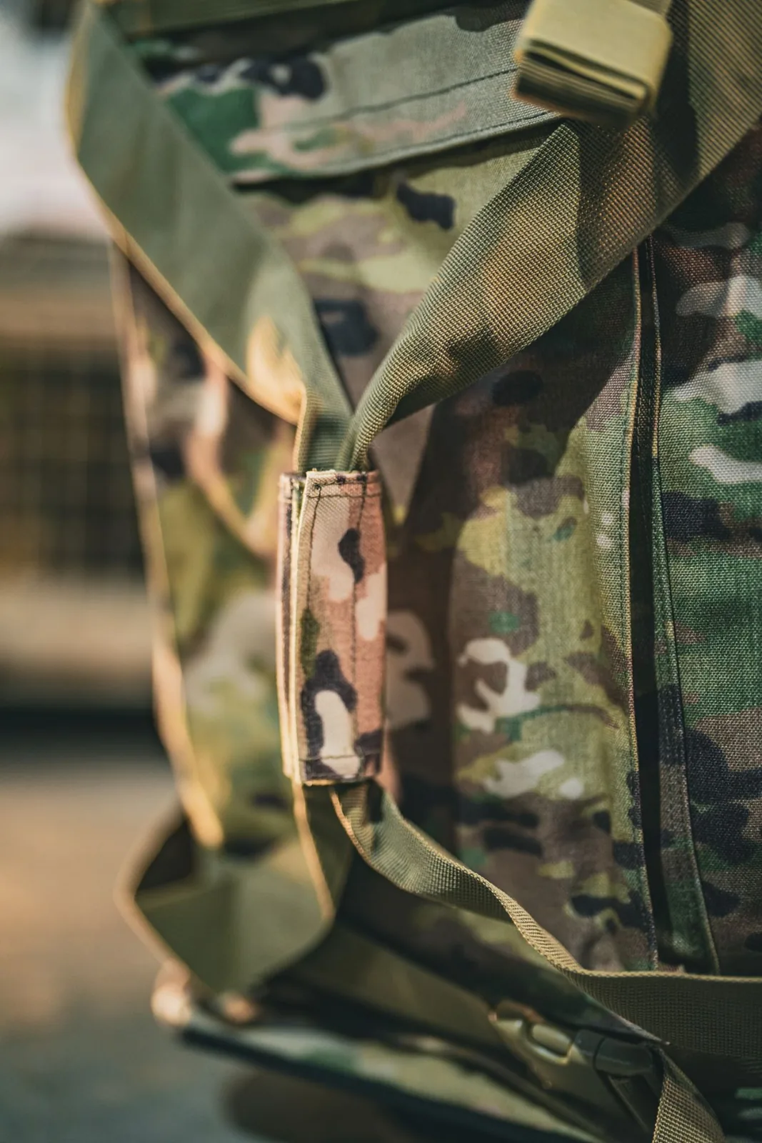 Multicam webbing keeper stitched at a stress point