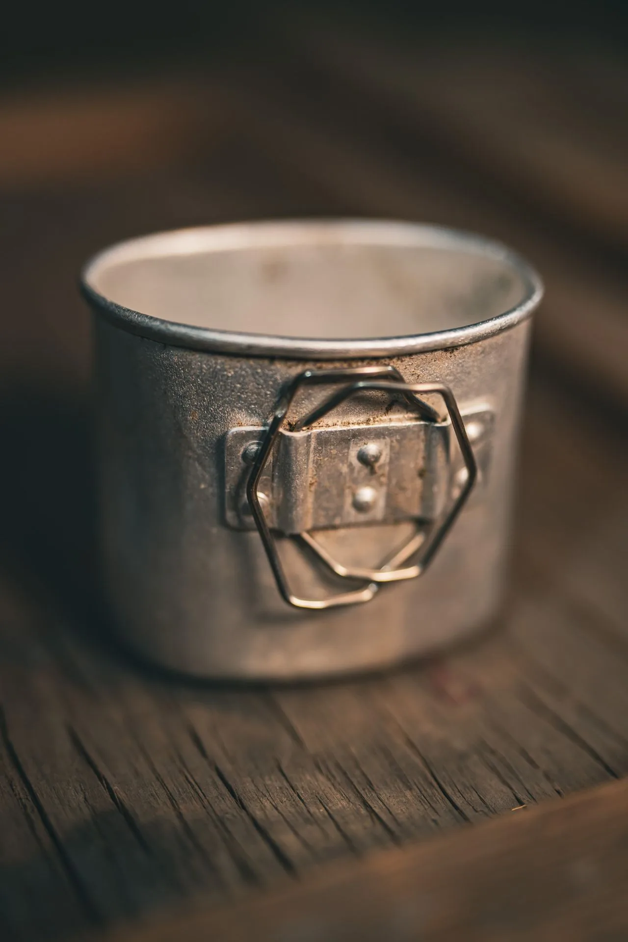 Aluminum drinking cup from the Romanian canteen kit with its folding butterfly wire handle riveted to the side
