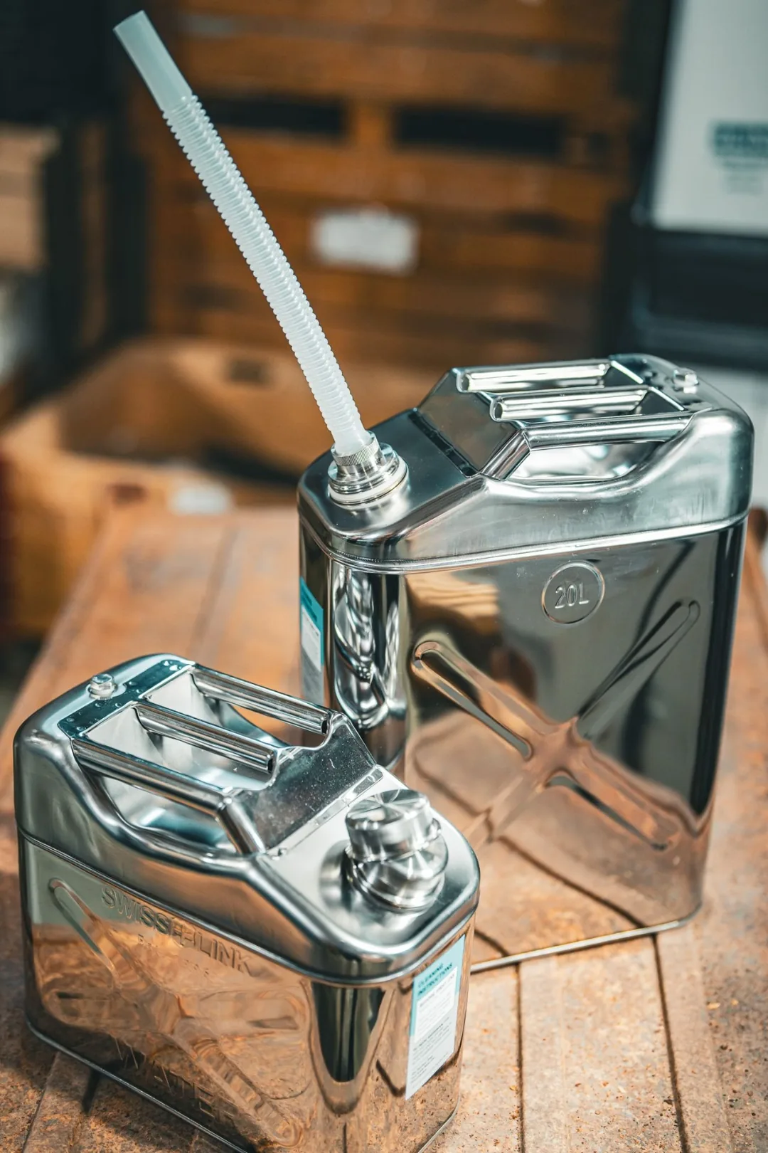 Swiss Link stainless steel water can, 10 liter and 20 liter side by side, with the free-flowing flex nozzle installed on the 20 liter can