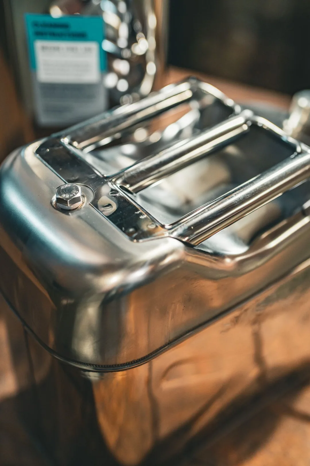Top view of the Swiss Link stainless steel water can showing the three-handle top and the welded seam around the handle assembly