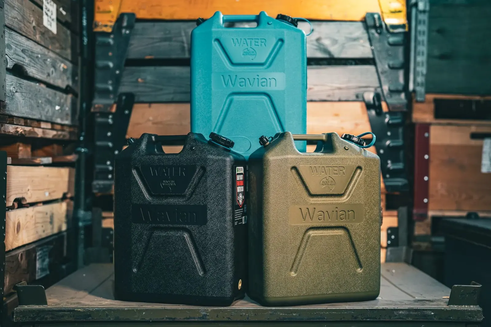 Wavian 22 liter water cans in blue, black and OD green stacked on a pallet in the Swiss Link warehouse